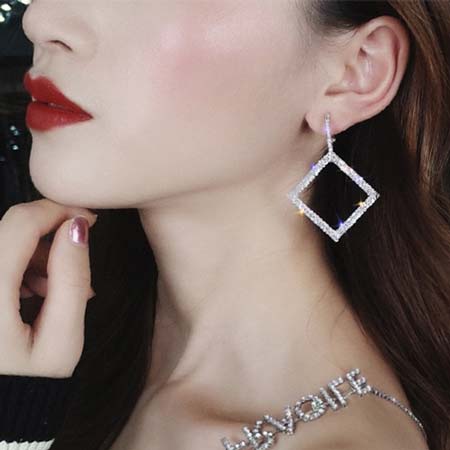 Woman-dressed-black-dress-wearing-Art-Deco-Zeus-Square-Crystal-Earrings-color-silver